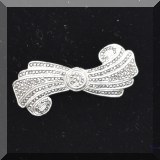 J085. Sterling silver rolled bow shaped pin. Missing one facet. 2”w - $22